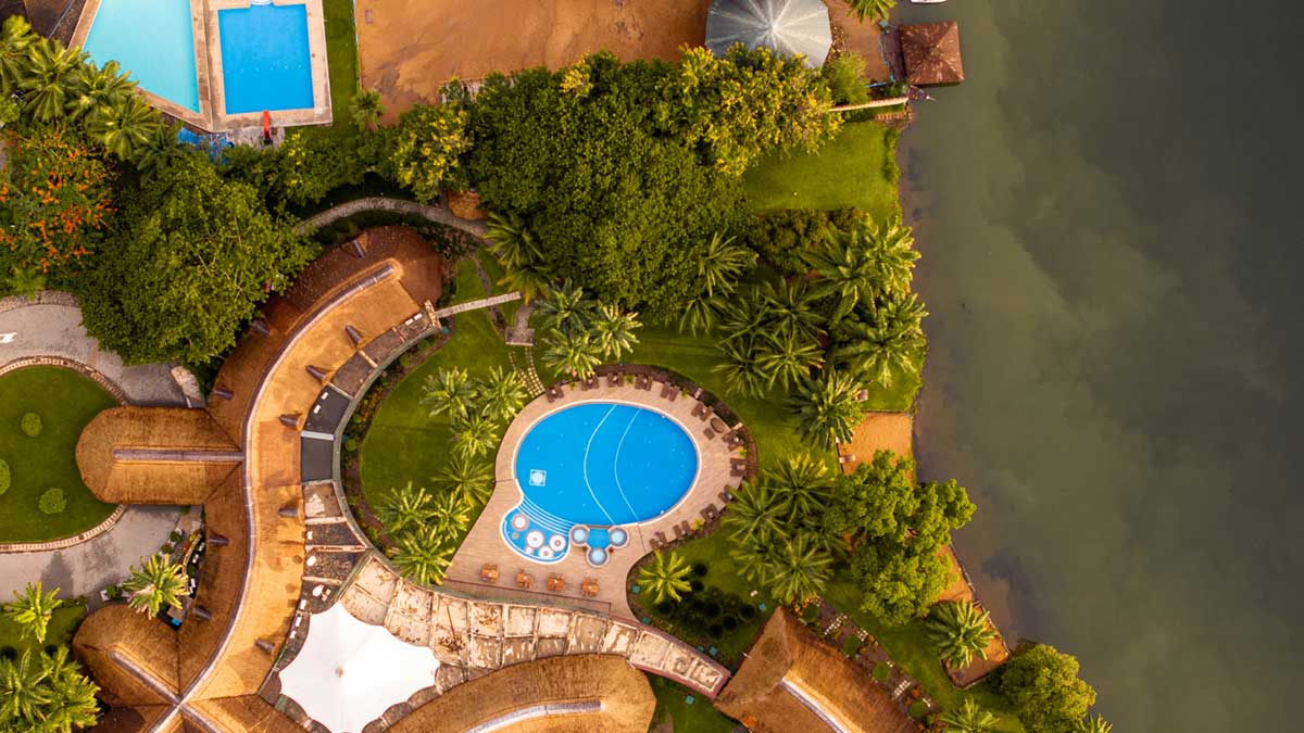 Aerial view of the swimming pool and the landscape at The Royal Senchi Hotel & Resort next to the Volta River in Ghana