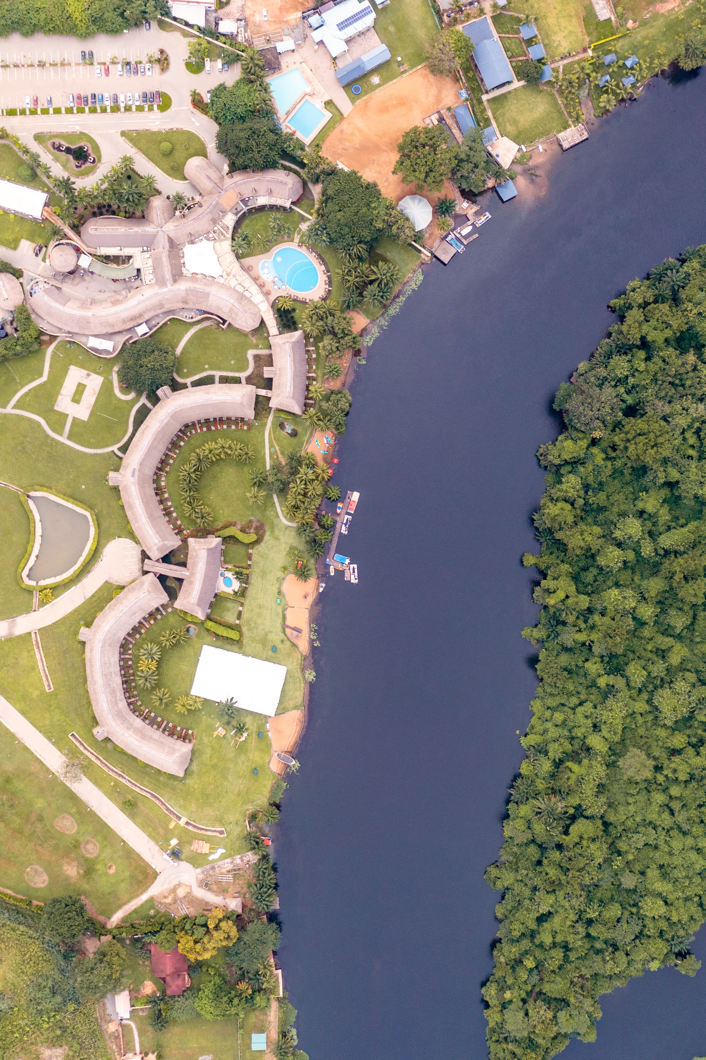 Aerial view of the swimming pool and the landscape at The Royal Senchi Hotel & Resort next to the Volta River in Ghana