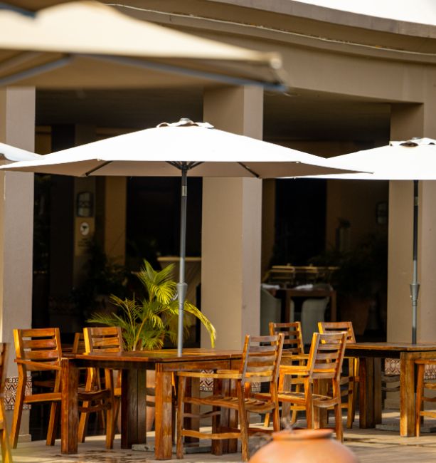 An image of the seating area near the main pool at The Royal Senchi Hotel & Resort in Ghana