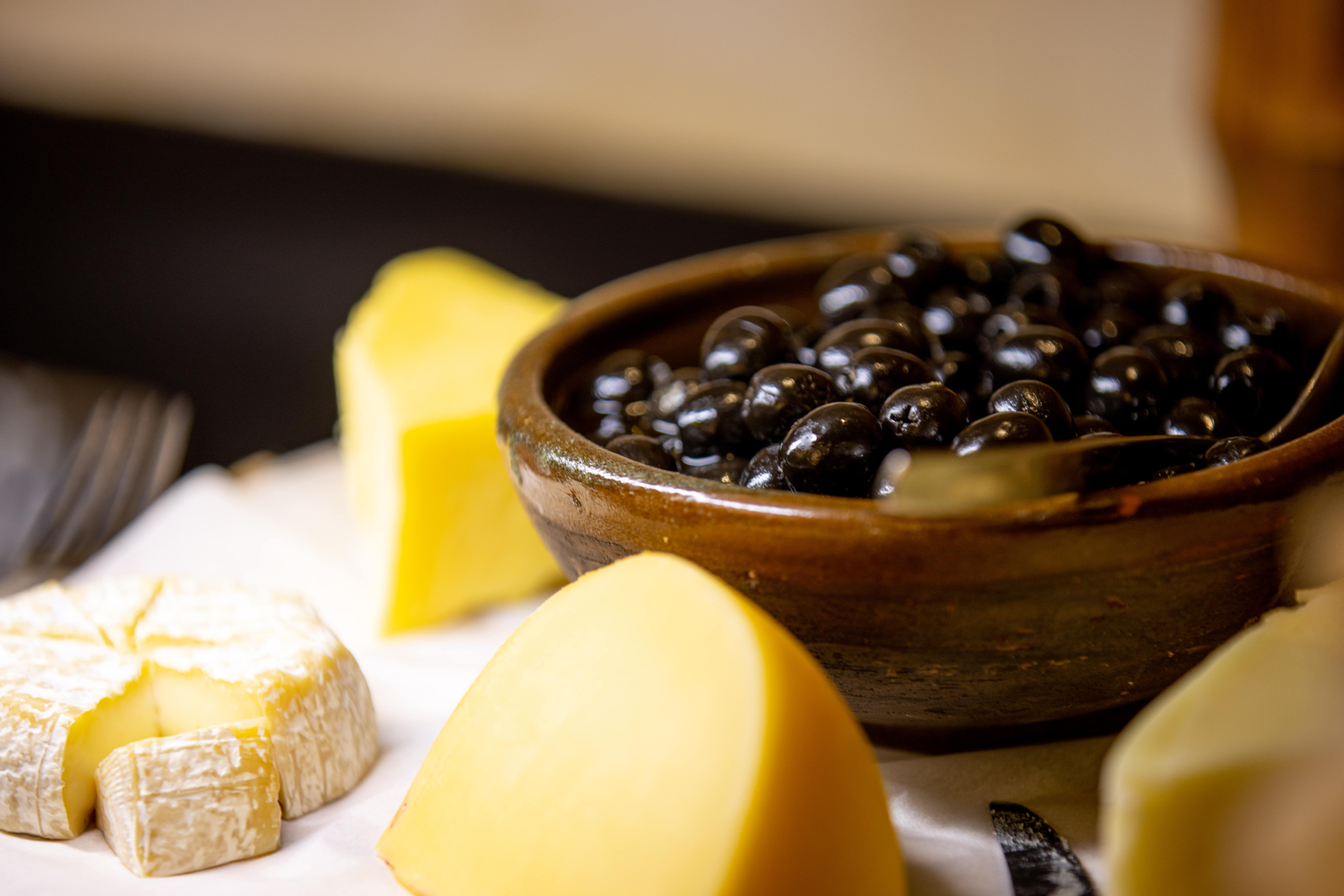 A close-up image of delicious olives and a variety of cheese being served at The Senchi Restaurant at The Royal Senchi Hotel and Resort in Ghana