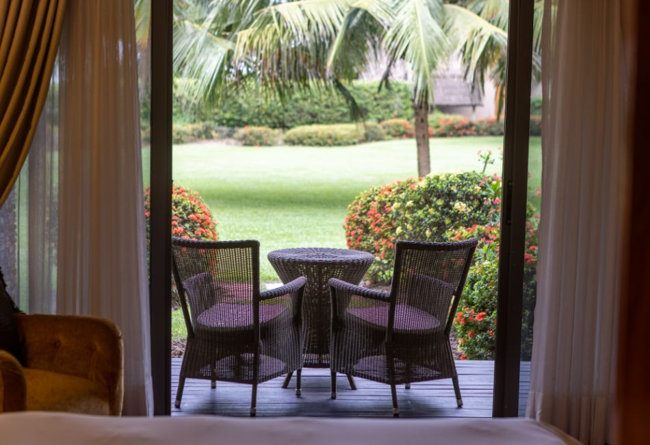 View of the seating area and the grounds from the River View Rooms at The Royal Senchi Hotel & Resort in Ghana