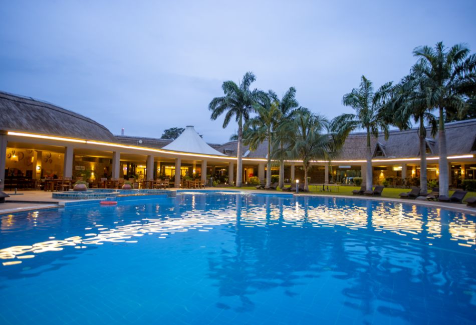 View of the swimming pool and the beach beds at The Royal Senchi Hotel & Resort, Ghana