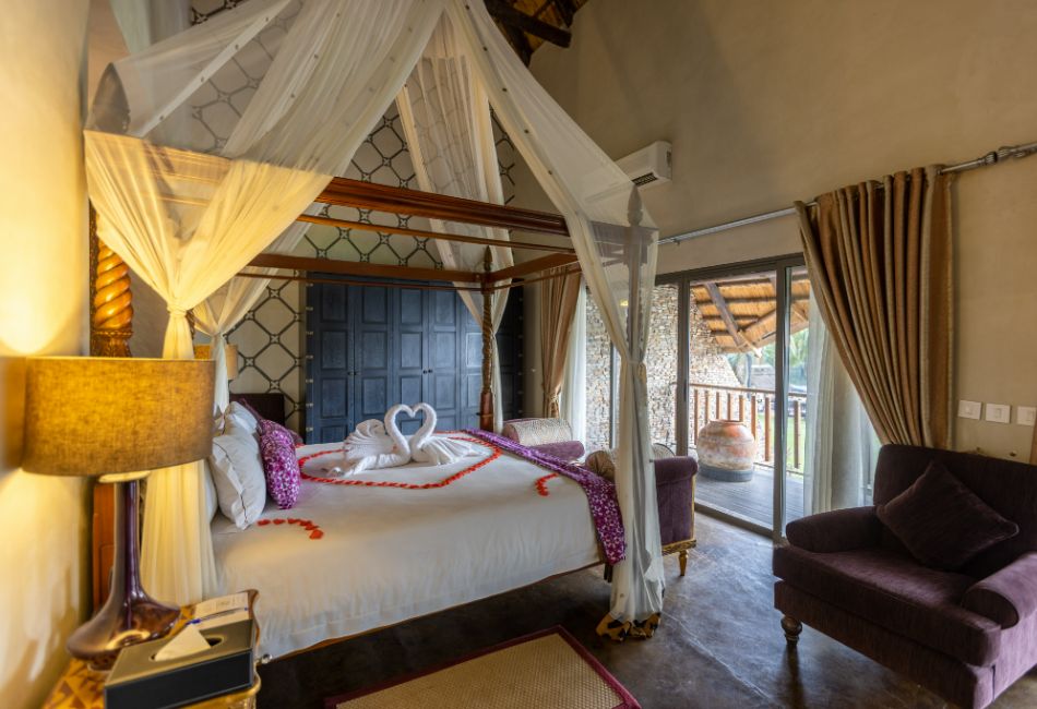 View of the four poster bed in The Picathartes Presidential Suite at The Royal Senchi Hotel & Resort, Ghana