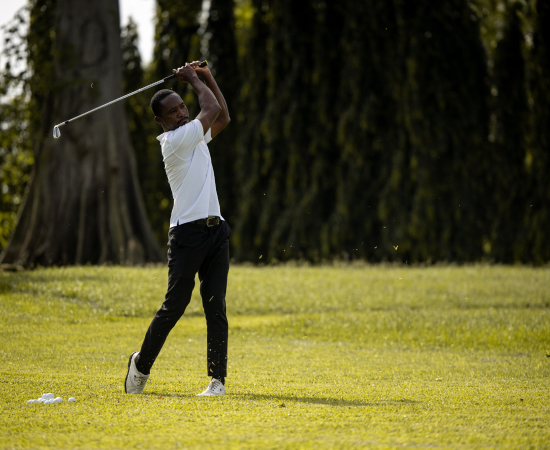 An image of a guest teeing off at the Golf Driving Range, one of the activities offered at The Royal Senchi Hotel and Resort in Ghana
