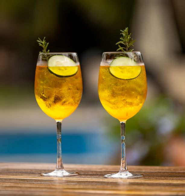 An image of two cocktails served in wine glasses at The Palm Lounge at The Royal Senchi Hotel & Resort in Ghana