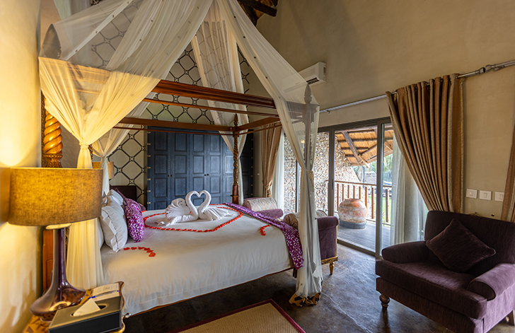 View of the four poster bed in The Picathartes Presidential Suite at The Royal Senchi Hotel & Resort, Ghana