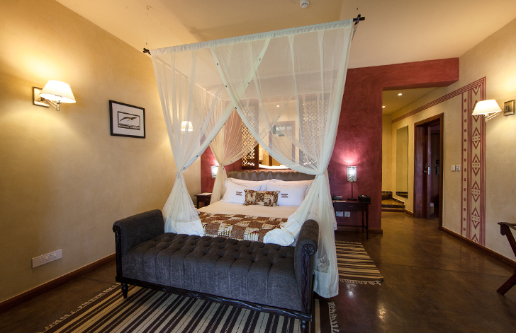 View of the four-poster bed in The River View Suite at The Royal Senchi Hotel & Resort, Ghana