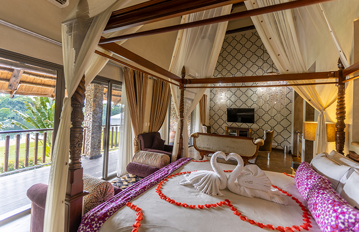 View of the four poster bed in The Picathartes Presidential Suite at The Royal Senchi Hotel & Resort, Ghana