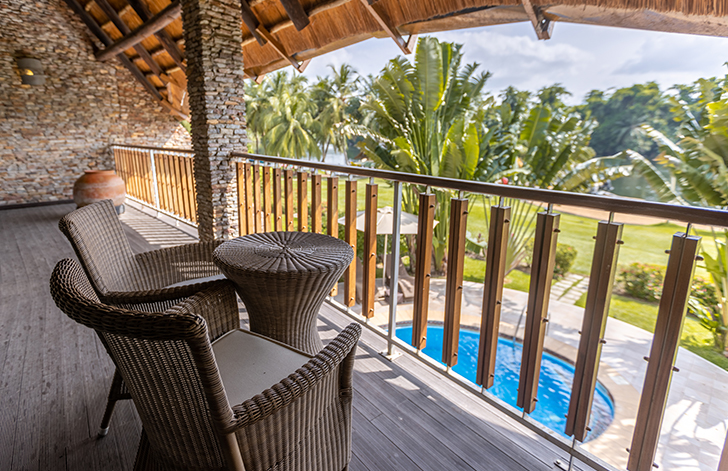 View of the pool and the lounge chairs outside at The Picathartes Presidential Suite at The Royal Senchi Hotel & Resort, Ghana